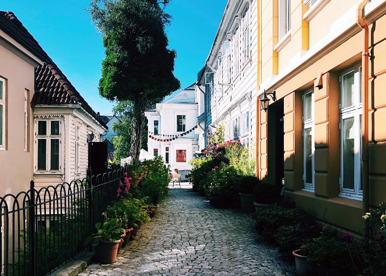 Gatemiljø med brostein og  gamle hus